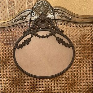 Ornate cast iron oval frame